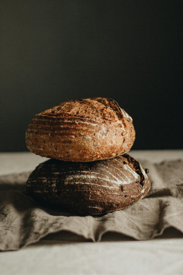 White and black loaves on table
